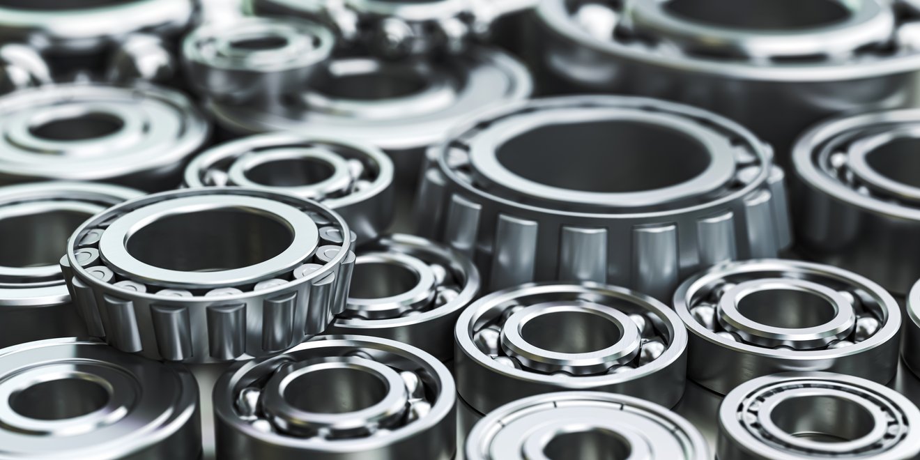 A diverse collection of ball and roller bearings of different sizes, showcasing the variety and versatility in modern machinery components.
